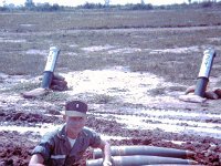John Girardeau.  The azimuth numbers are visible on some of the powder canisters sticking out of the ground in a circle around the gun.  The canisters were used as reference aiming points to help relay the gun when it had to “swing trails” to another azimuth of fire.